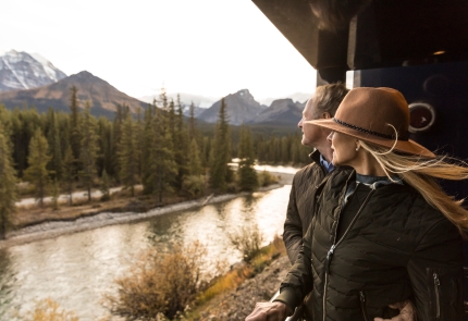Guests on the outdoor viewing platform onboard Rocky Mountaineer