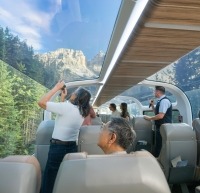 Guests looking through glass-dome coaches.