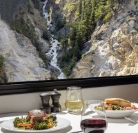 Alberta Striploin steak and salmon with scenery Stoney Creek out the window. GoldLeaf Culinary 2023