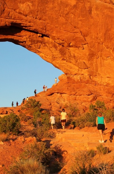 Hikers explore the magnificent archways at Arches National Park, Moab, Utah