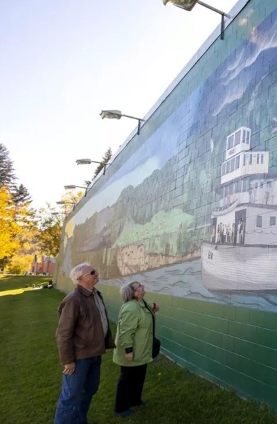 Visitors looking at the LeBourdais Park mural.
